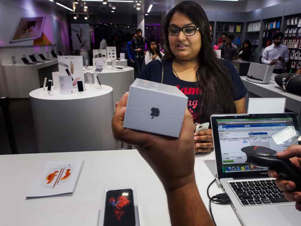 Aarushi, the first customer to buy an Apple Inc. iPhone 6s at an iZenica store, operated by Zenica LifestylePvt., waits to pay during a midnight launch event for the Apple Inc. iPhone 6s in New Delhi.