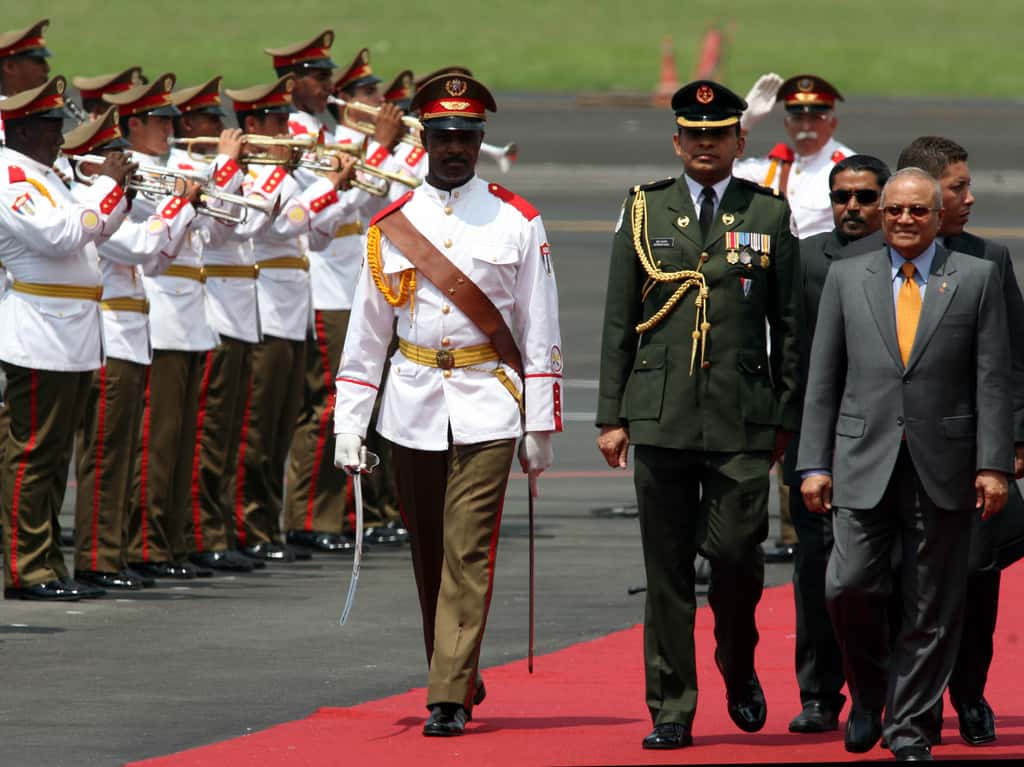 Maumoon Abdul Gayoom, then-President of Maldives, right, receives military honours upon his arrival at Jose Marti Airport in Havana, Cuba on September 14, 2006. (Photographer: Diego Giudice/Bloomberg News)