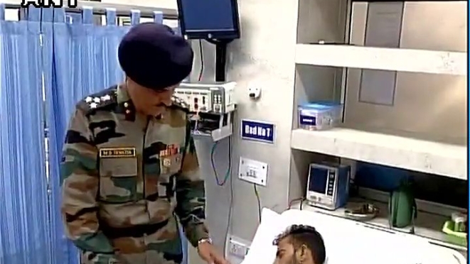 A doctor attends to an injured soldier.