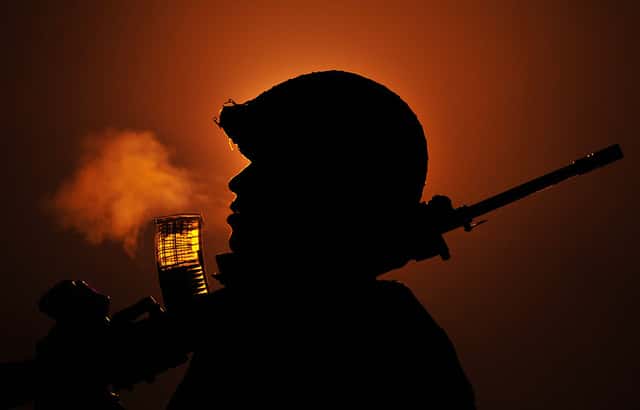 A security forces personnel patrolling the International border in Kashmir during a foggy winter night.  (Nitin Kanotra/Hindustan Times via Getty Images) 