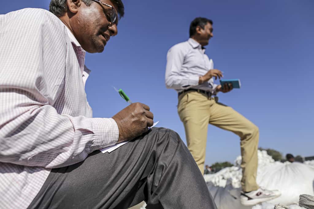 Traders attend an auction at a market in Rajkot, Gujarat, India. (Photographer: Dhiraj Singh/Bloomberg)